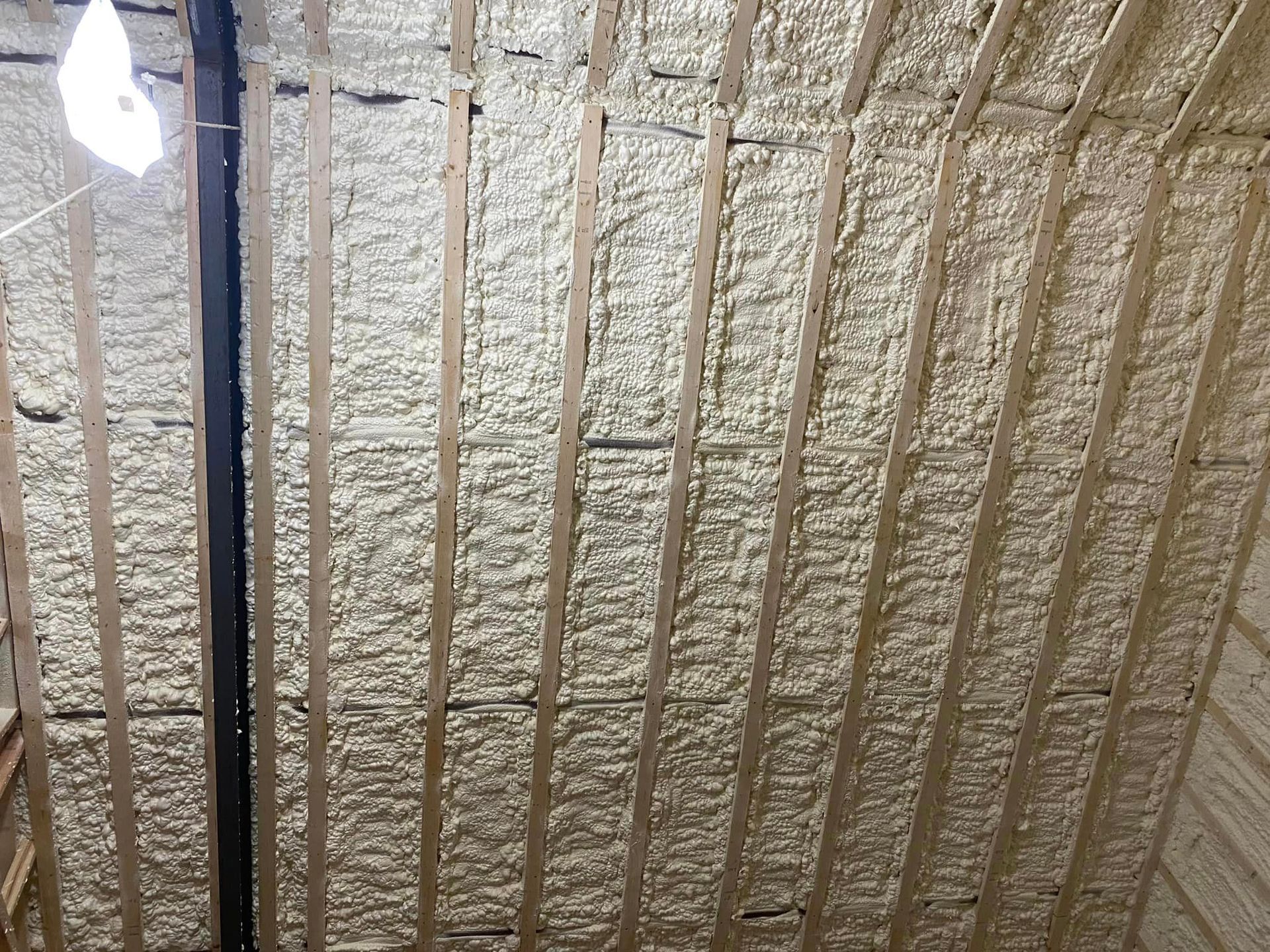 a ceiling with a lot of foam on it and wooden beams .