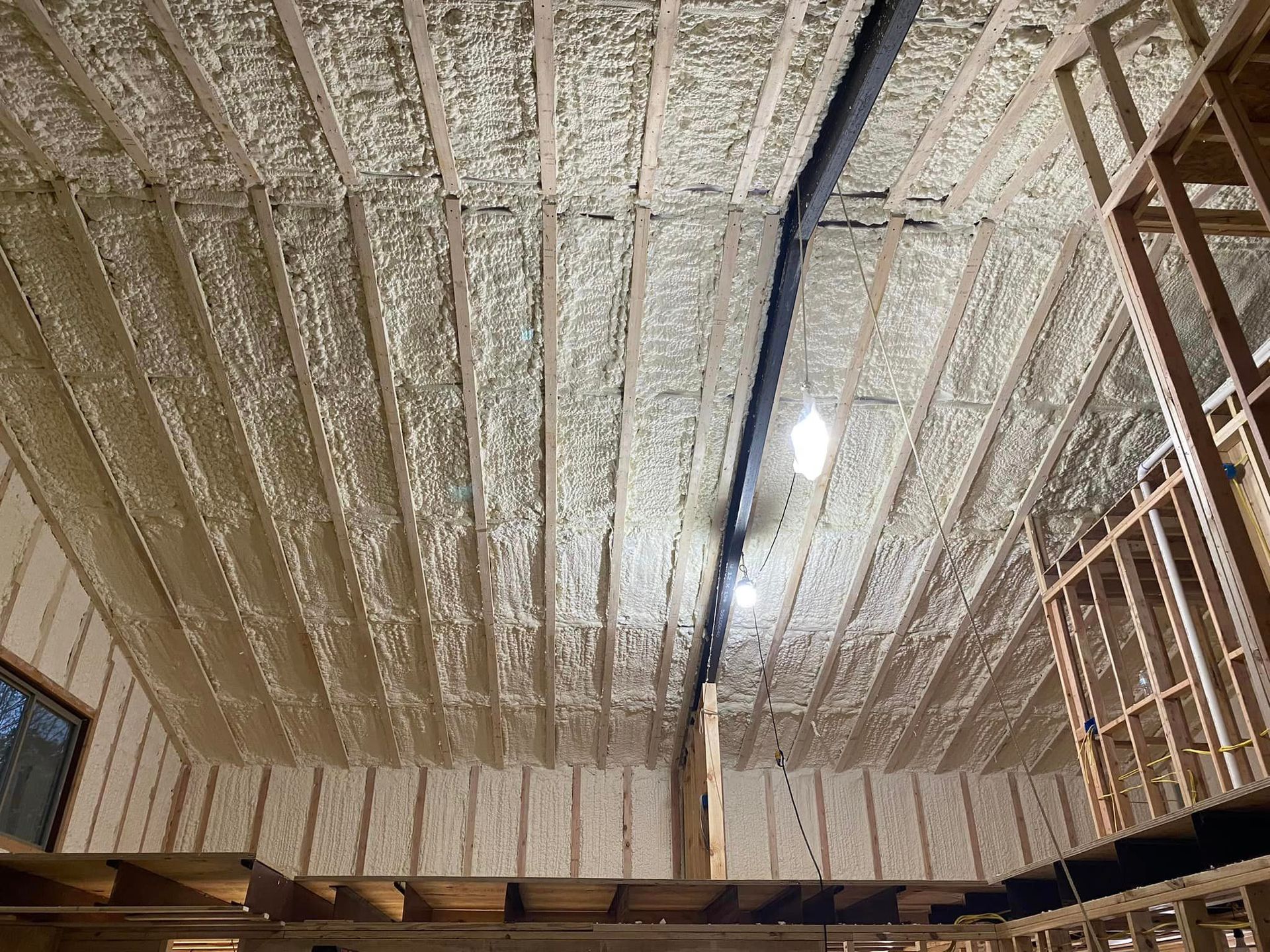 the ceiling of a building is covered in foam and there is a light on the ceiling .