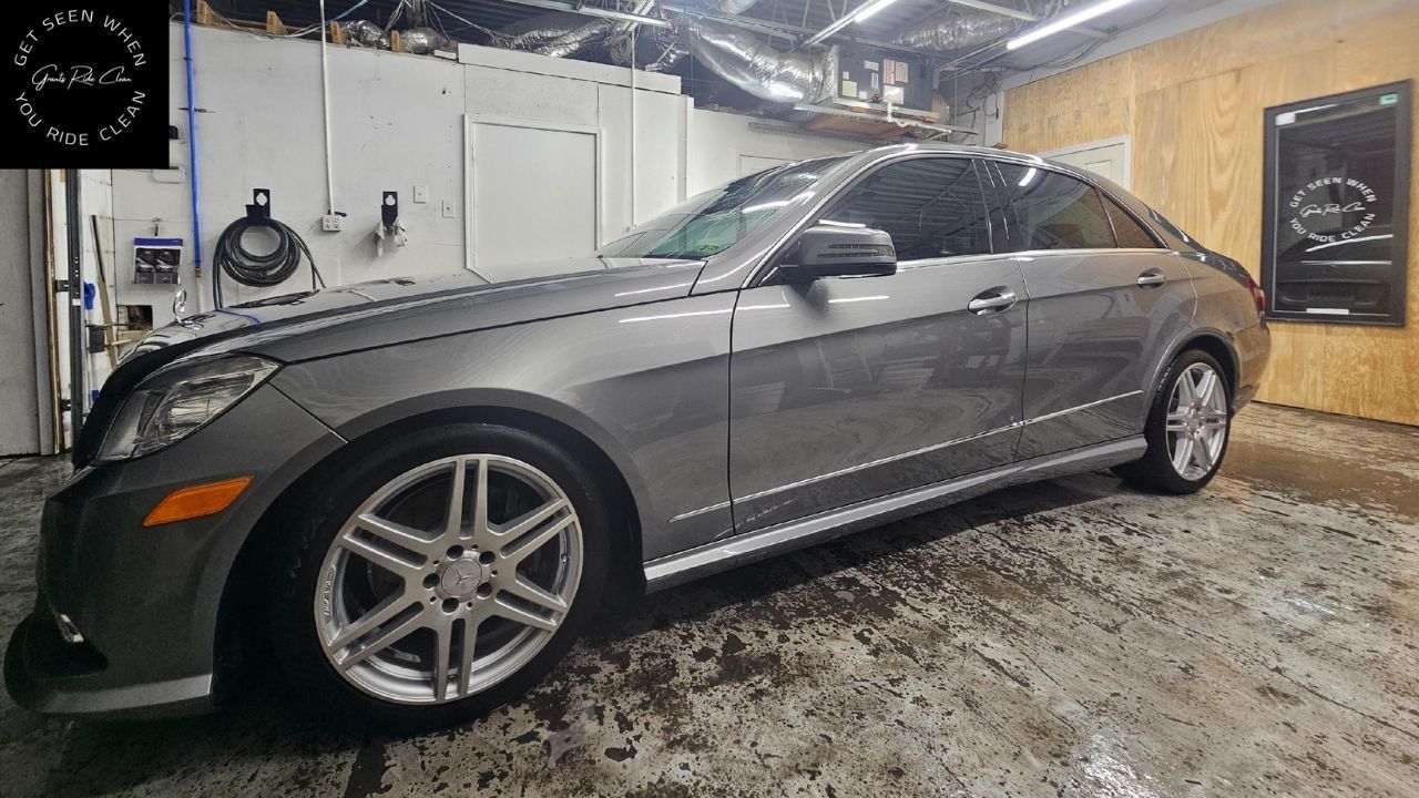 Gray Mercedes coupe parked inside a garage, with tinted windows and custom wheels.