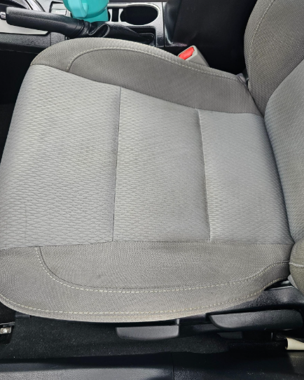 Gray car seat with textured fabric.