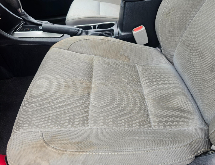 Dirty tan car seat.