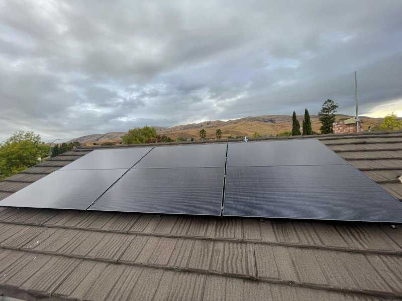 A solar panel is sitting on top of a roof.