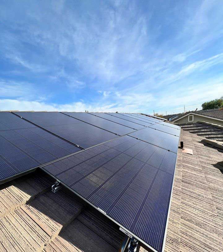 A row of solar panels are sitting on top of a wooden roof.