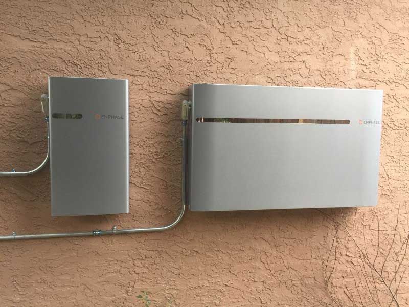 A solar panel is mounted on the side of a building.