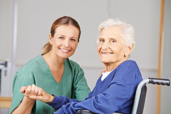Happy senior woman with her nurse