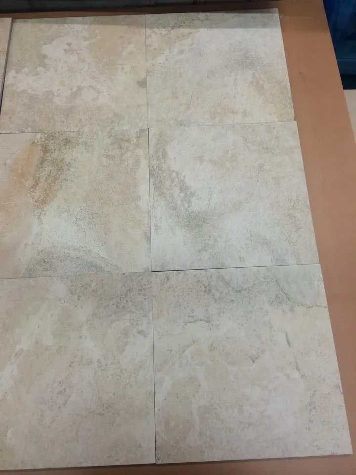 Six beige rectangular tiles arranged in a grid pattern on a brown surface.