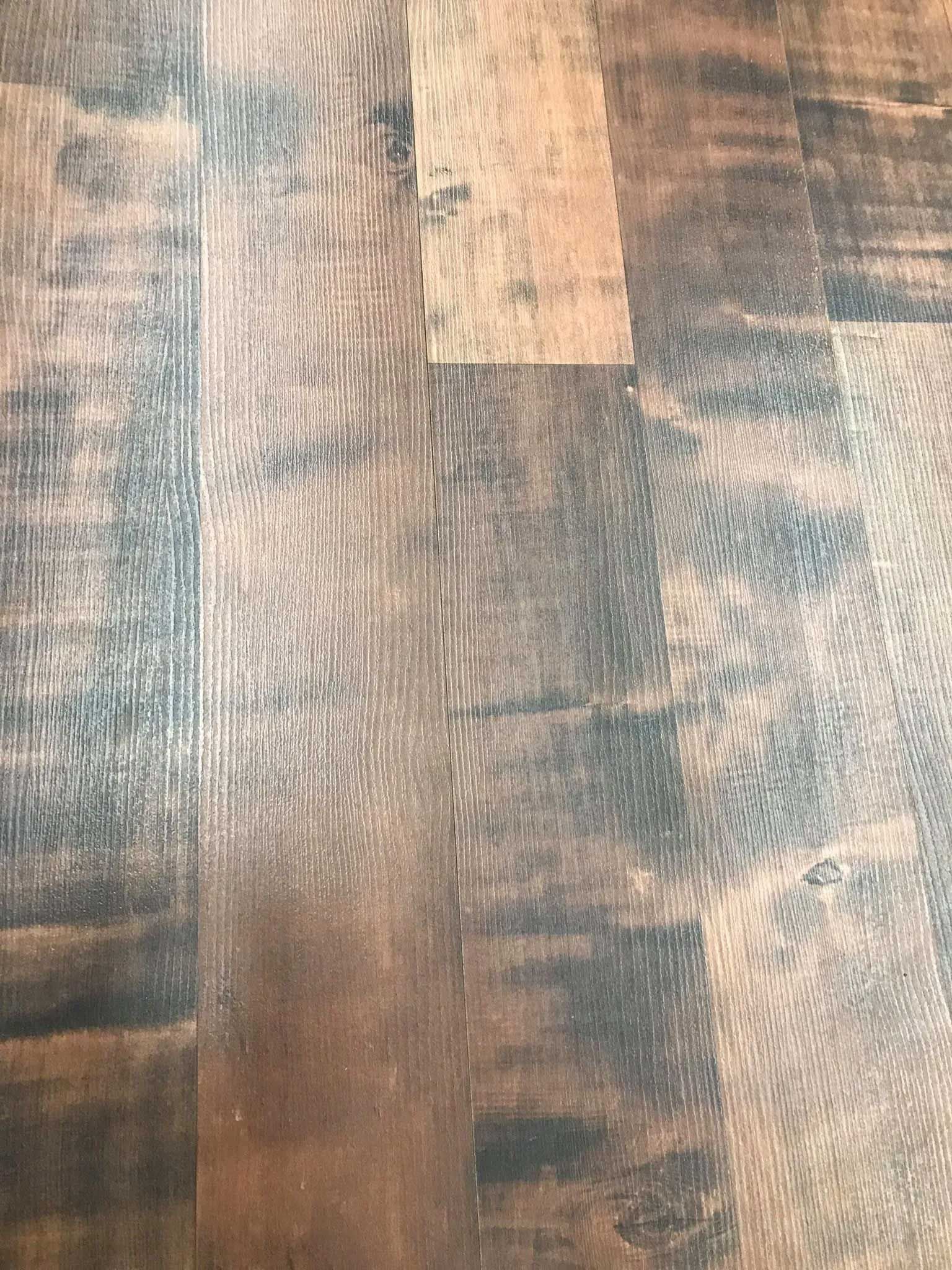 Close-up of dark wood flooring with various shades of brown and black.