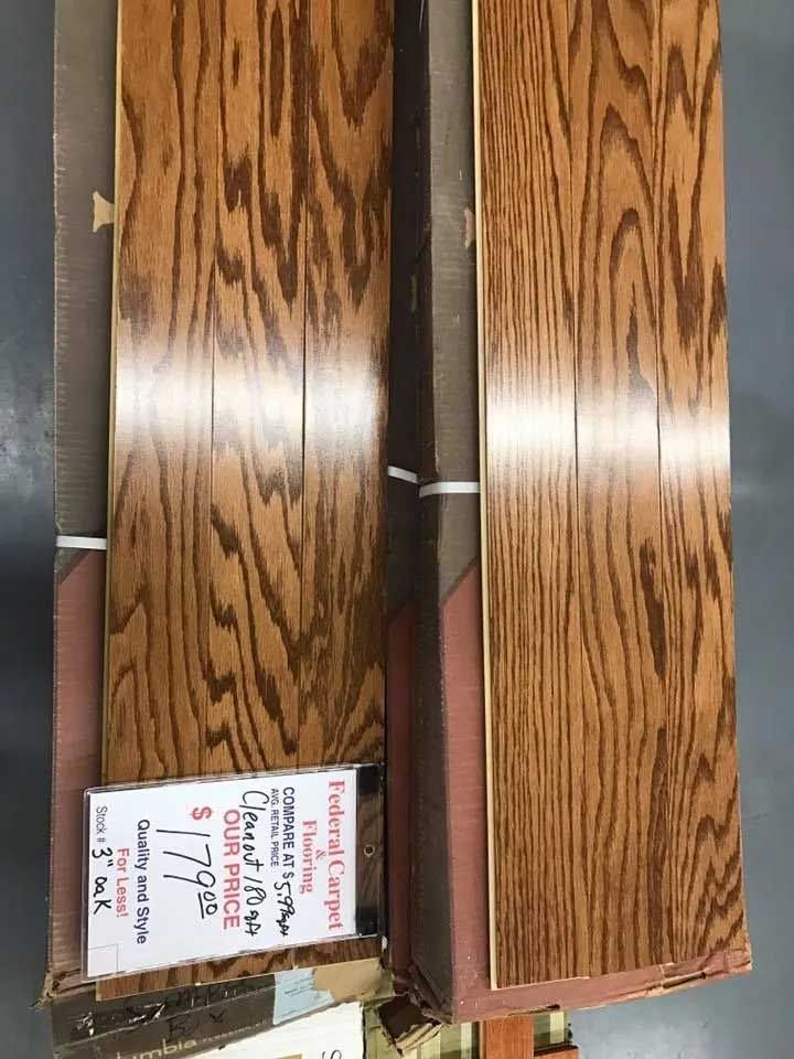 Two bundles of wood flooring with a price tag, showing a wood grain pattern.