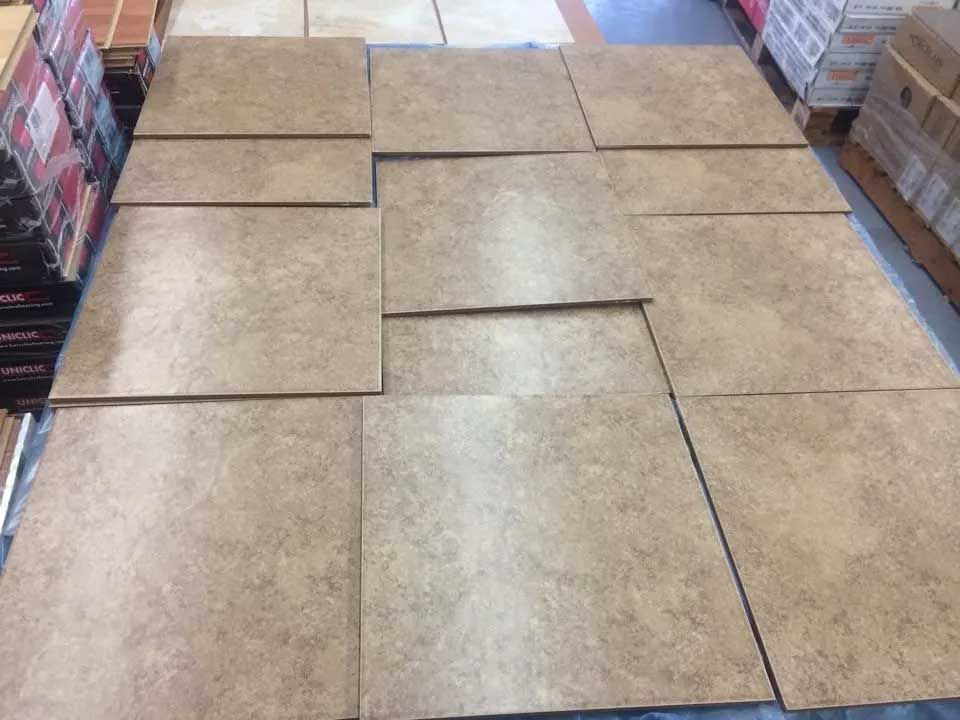Tan ceramic tiles arranged on a surface in a store setting.
