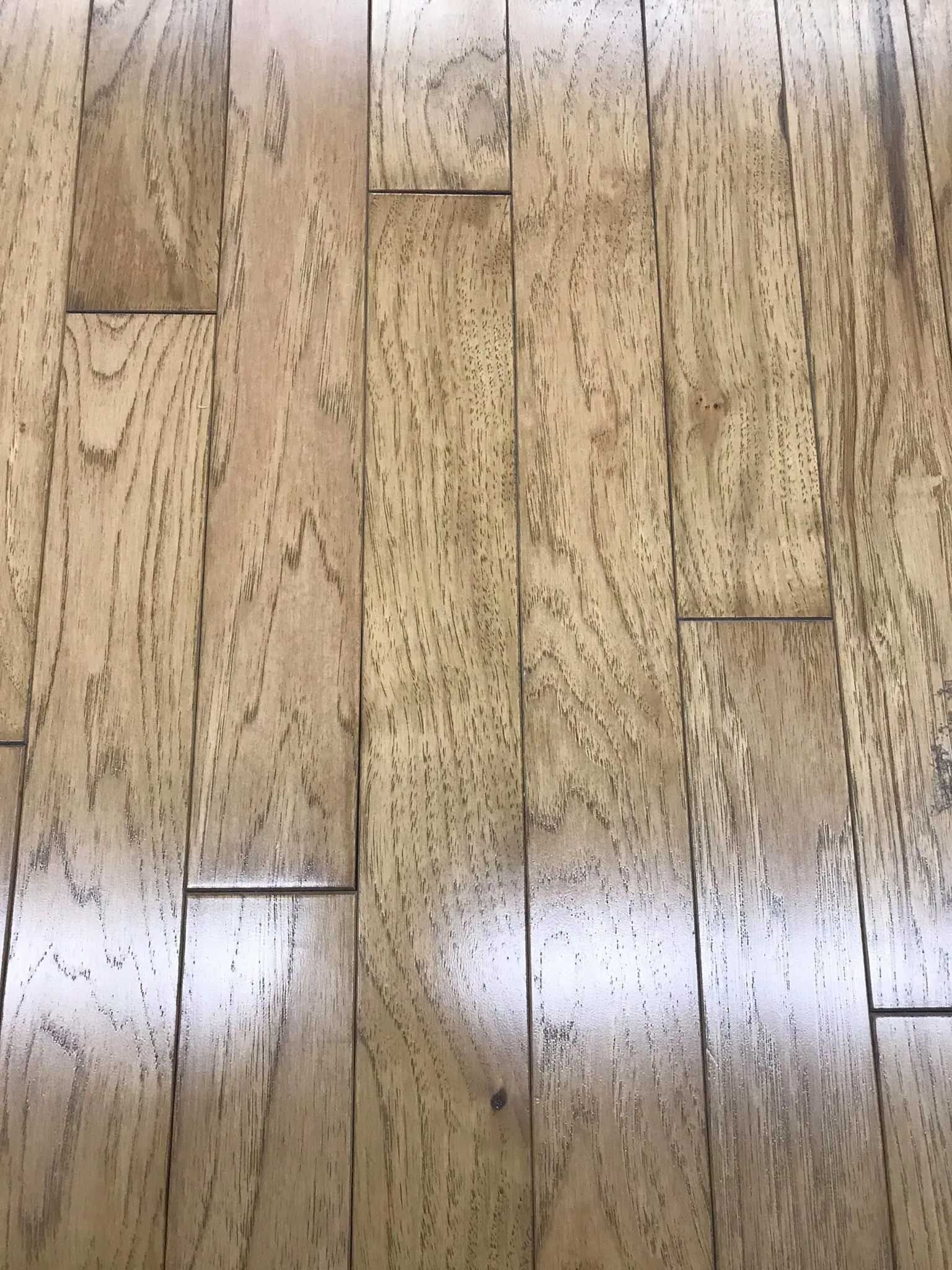 Wooden floor with varied light and dark brown planks.