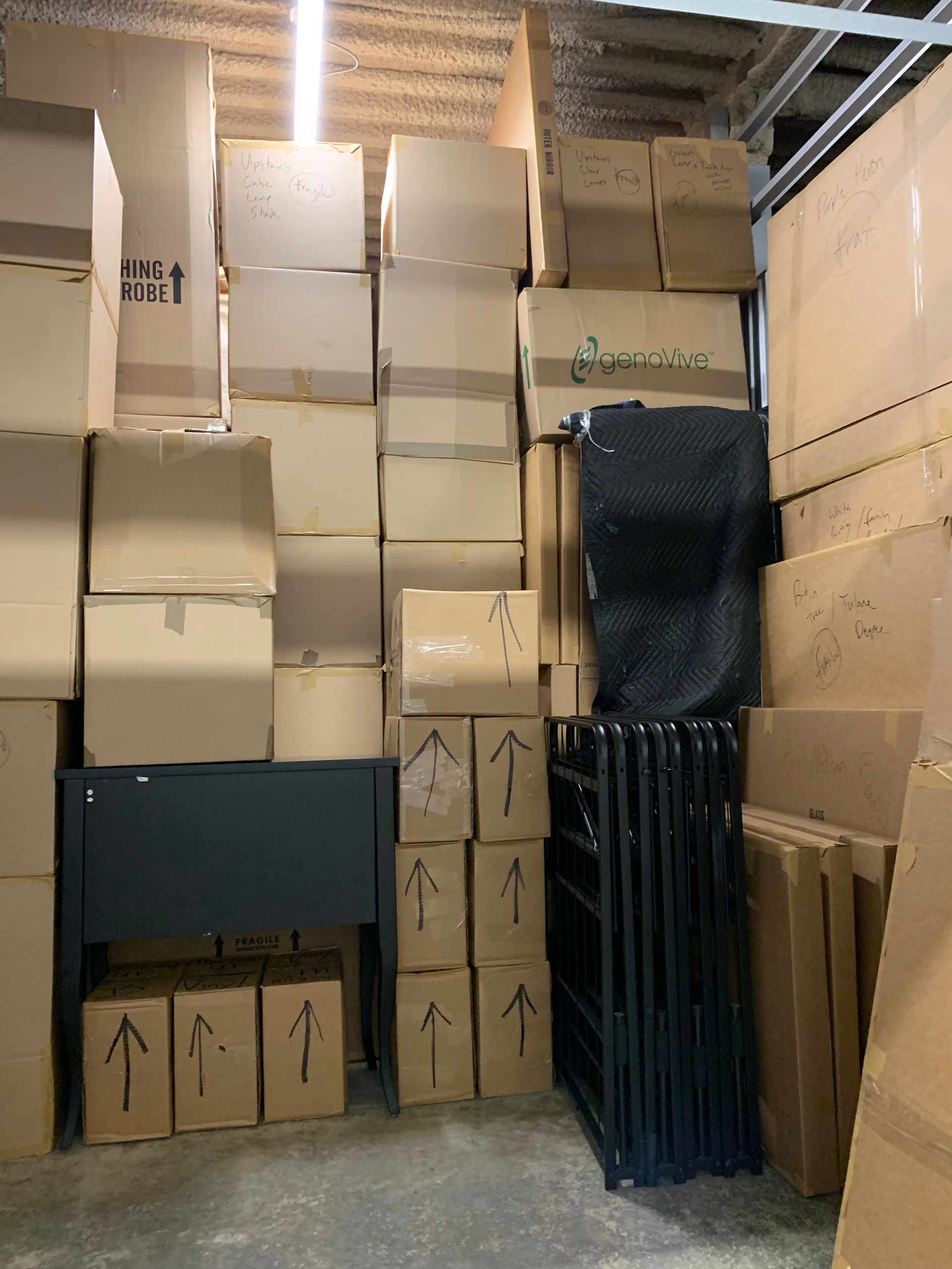 A warehouse filled with lots of cardboard boxes with arrows pointing up
