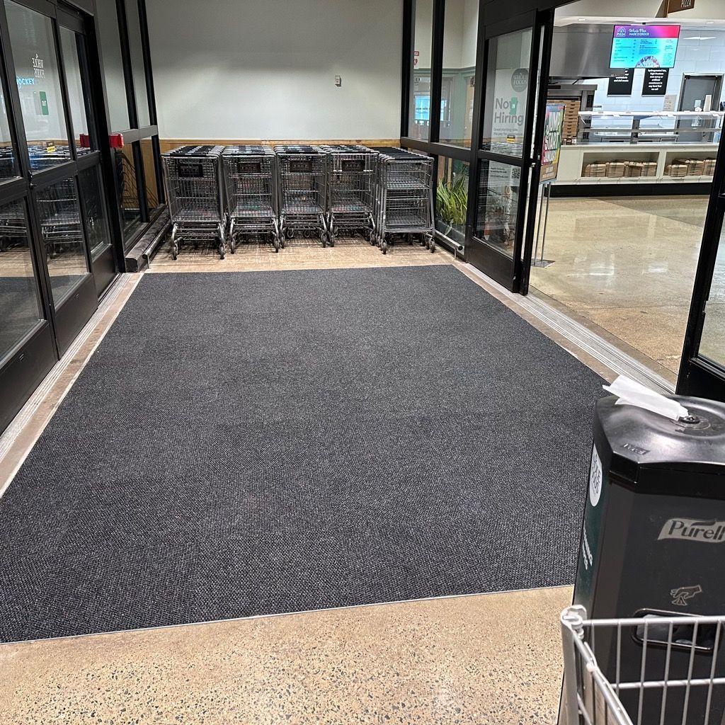 A row of shopping carts are lined up in a store.