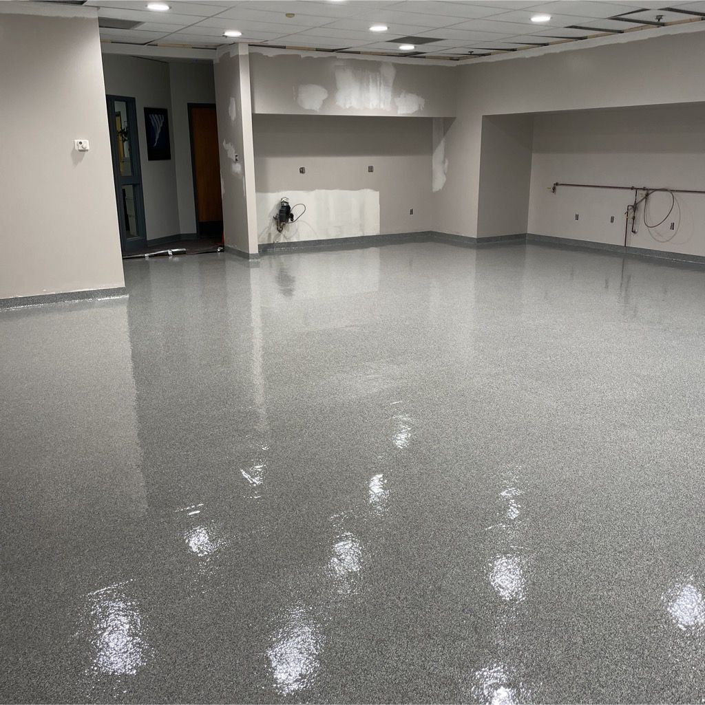 A large room with a gray floor and white walls.