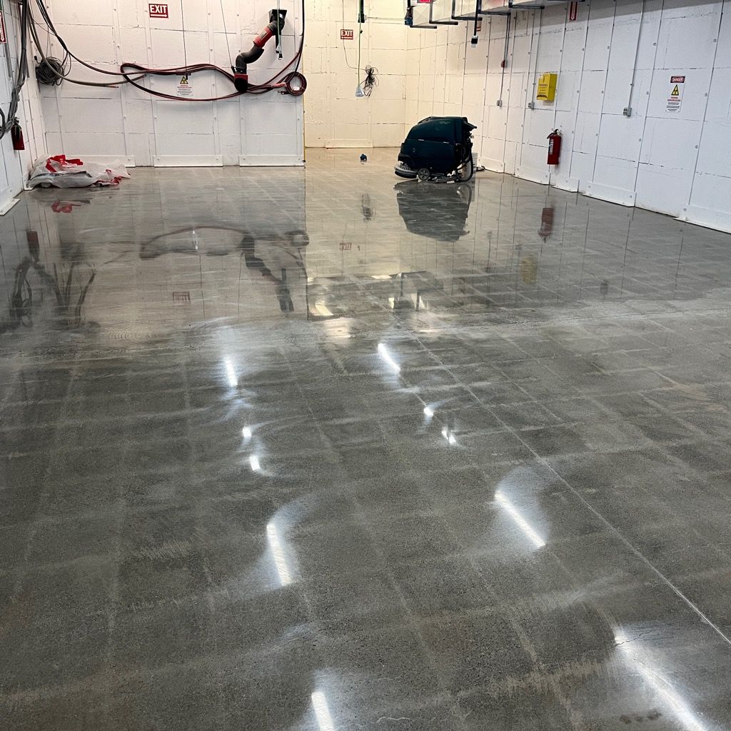 A large room with a shiny concrete floor and white walls.