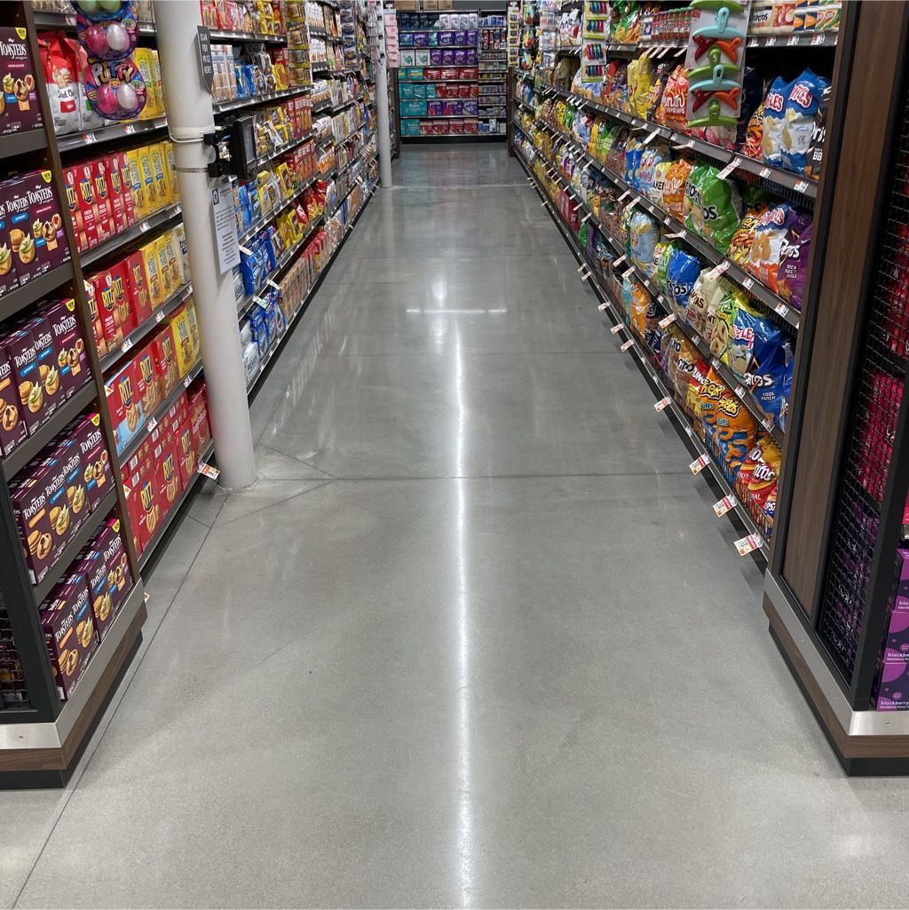A long aisle in a grocery store filled with lots of products.