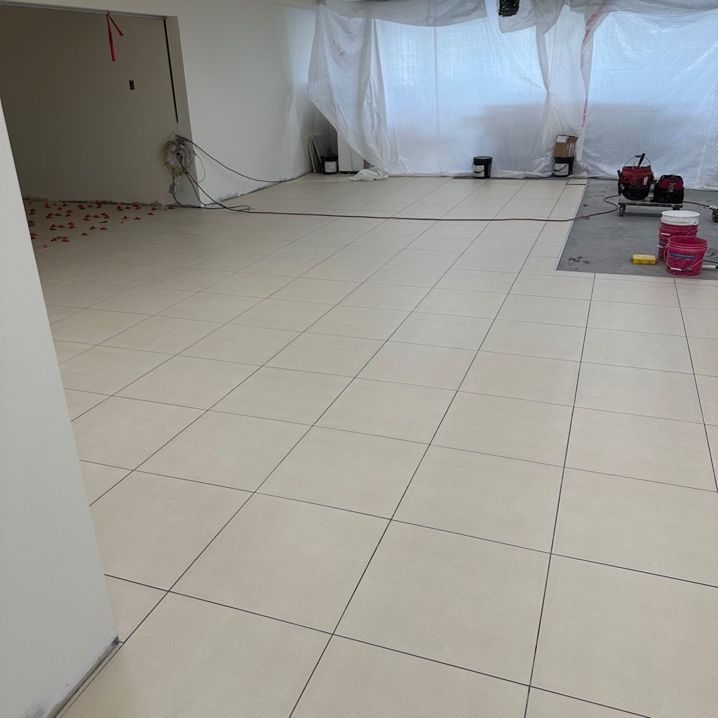 A large empty room with white tile floors.