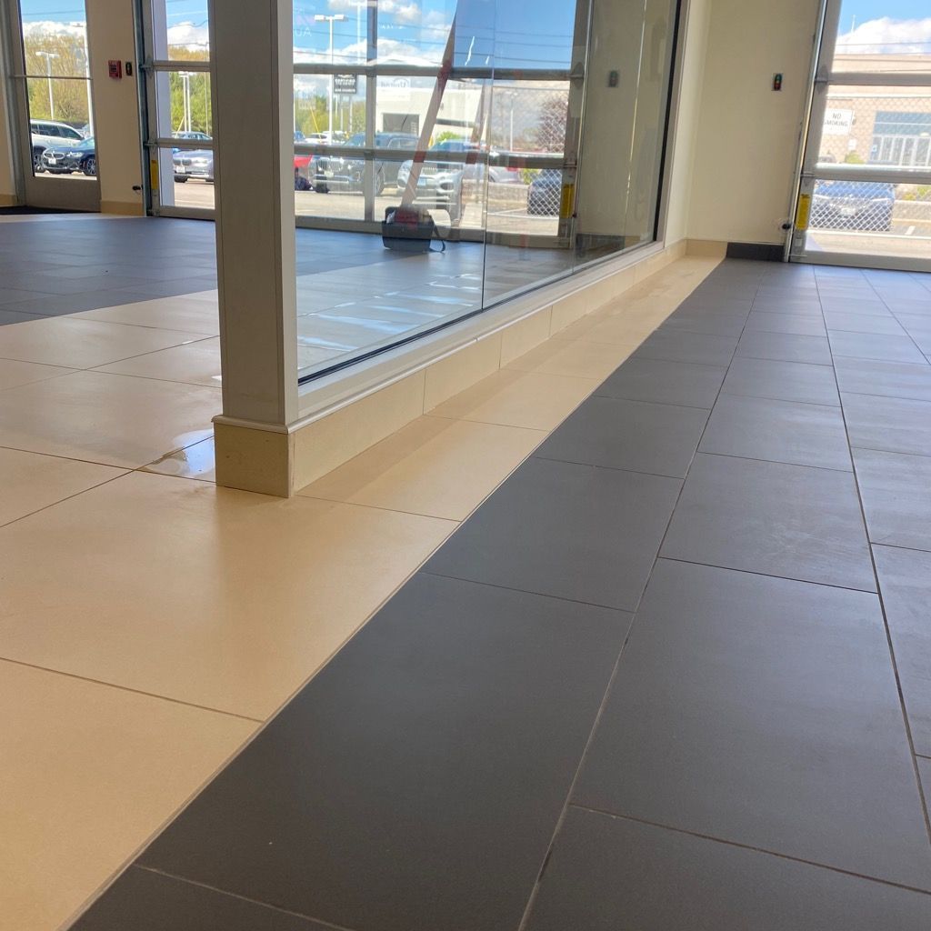 A room with a lot of windows and a tiled floor.