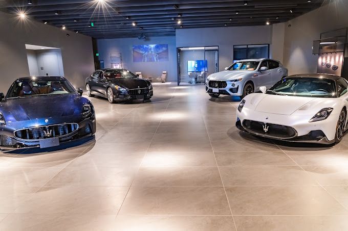 Three maserati cars are parked in a showroom.
