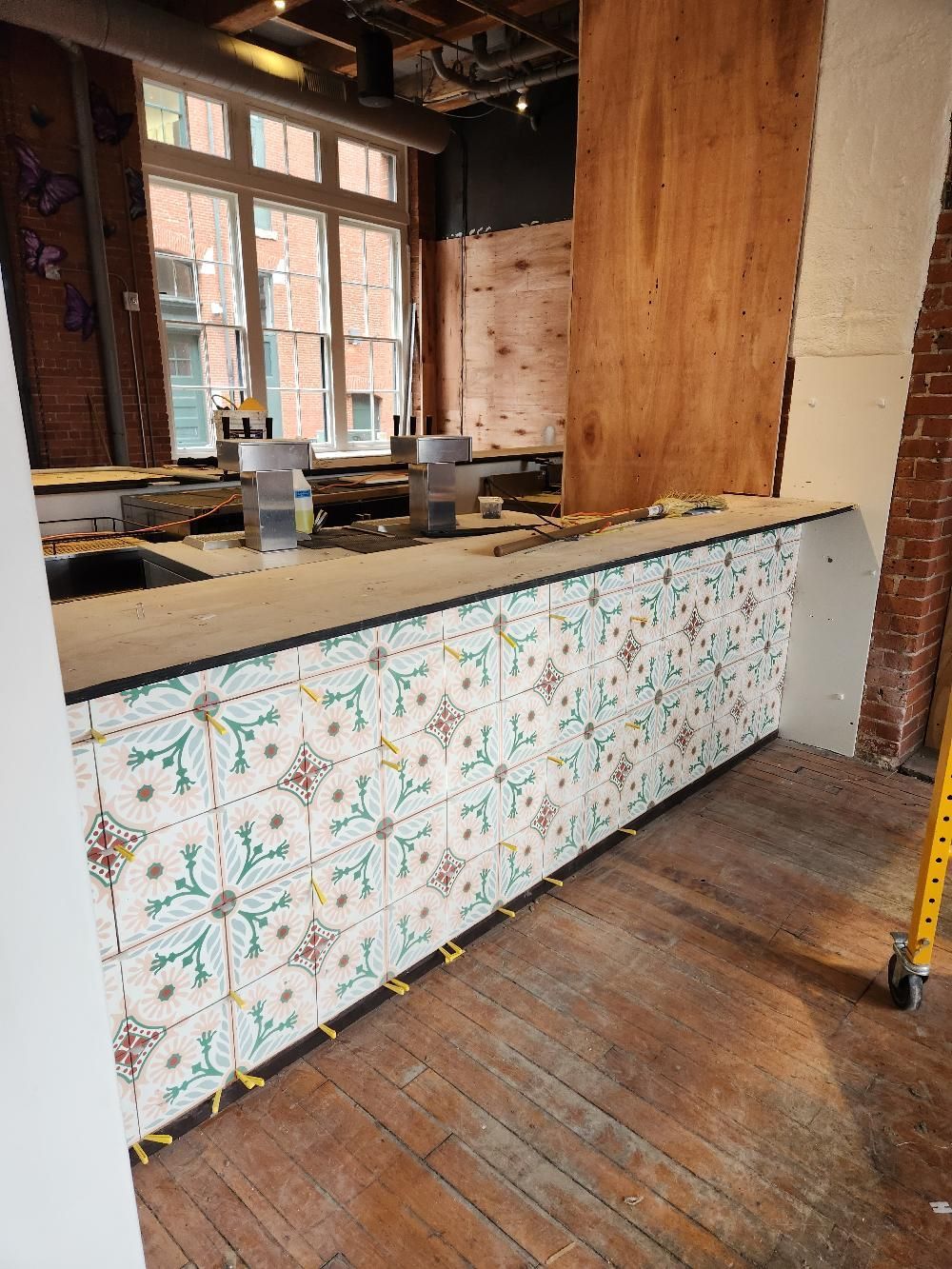A long counter in a room with a wooden floor.