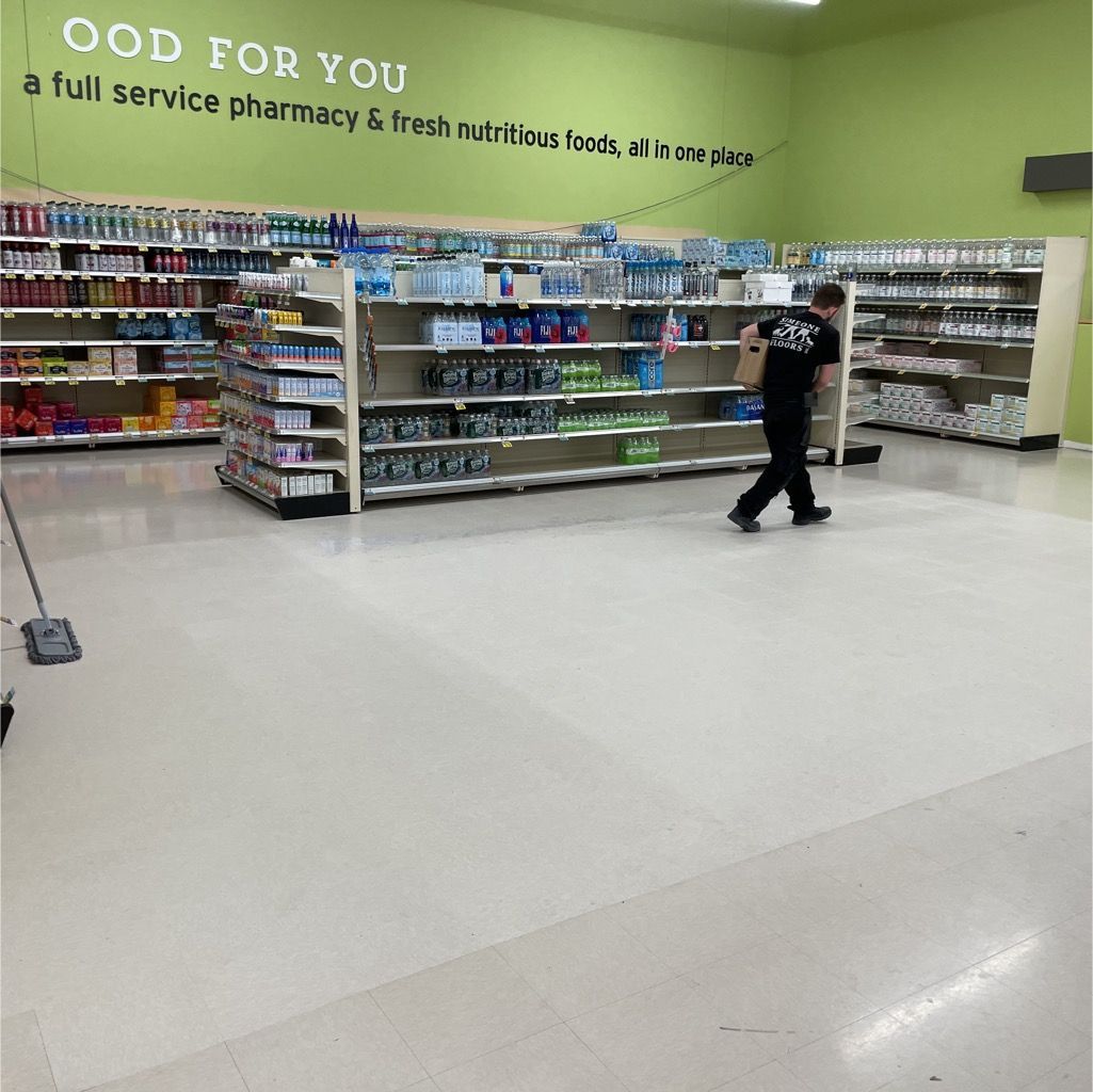 A man in a black shirt is shopping in a pharmacy.