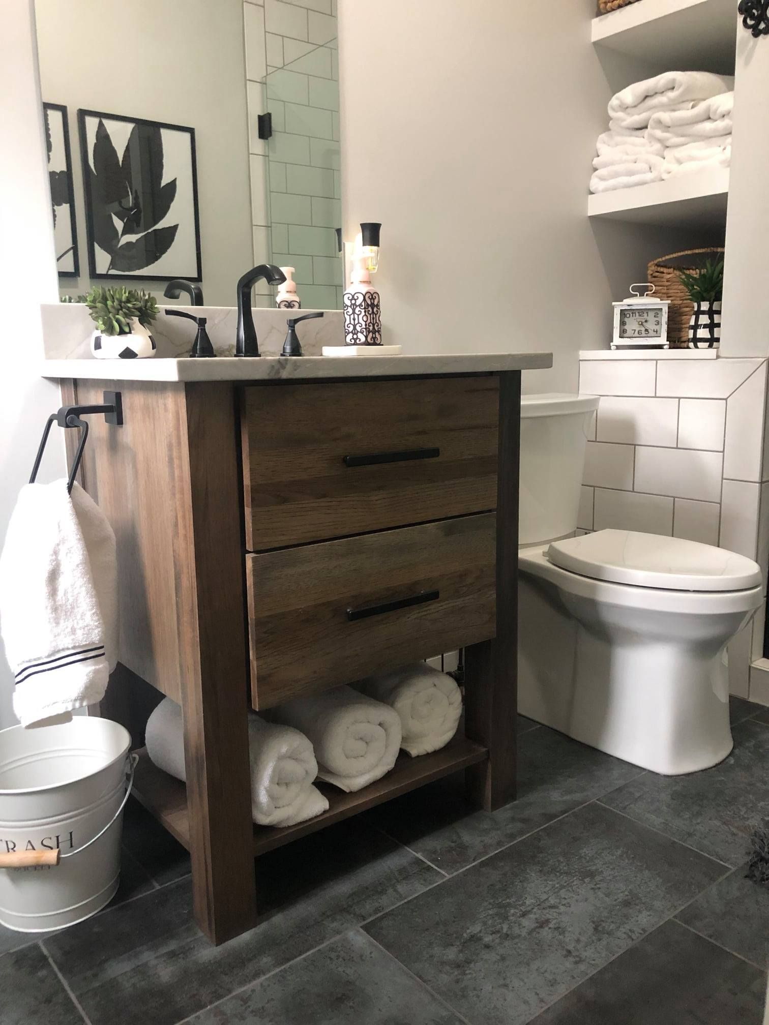 A bathroom with a toilet , sink , and mirror.