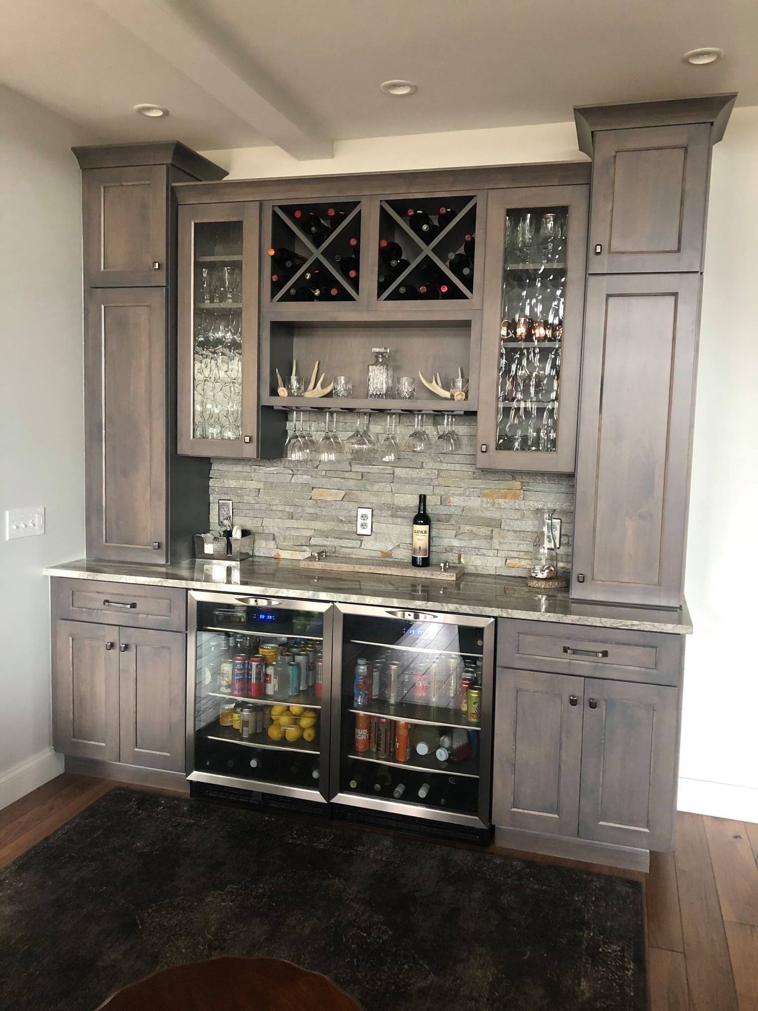 A kitchen with lots of cabinets and a wine fridge