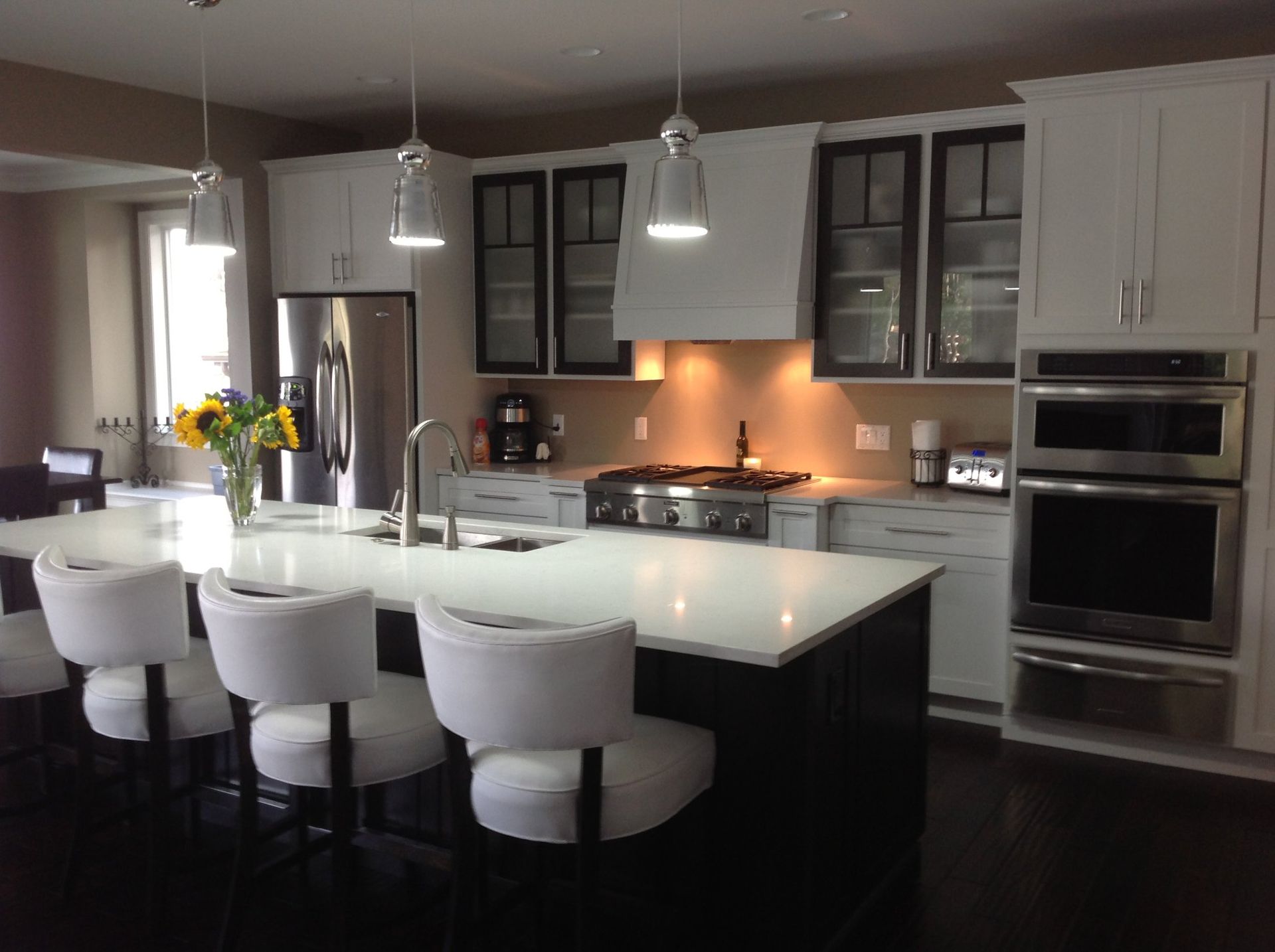 A kitchen with white cabinets and stainless steel appliances