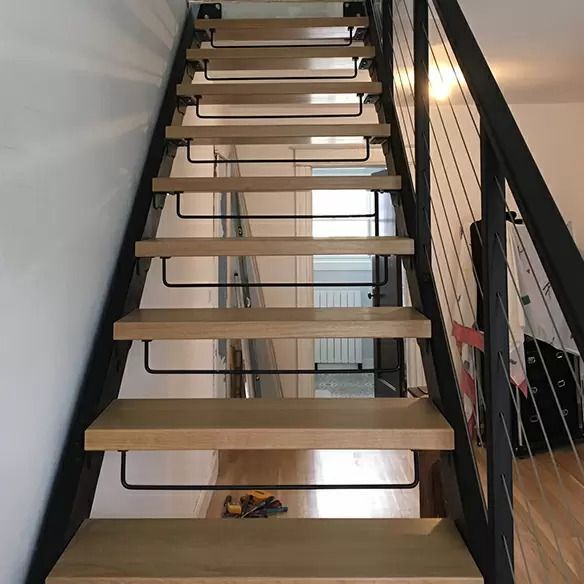 A staircase with wooden steps and a metal railing
