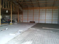 The inside of a building under construction with a concrete floor