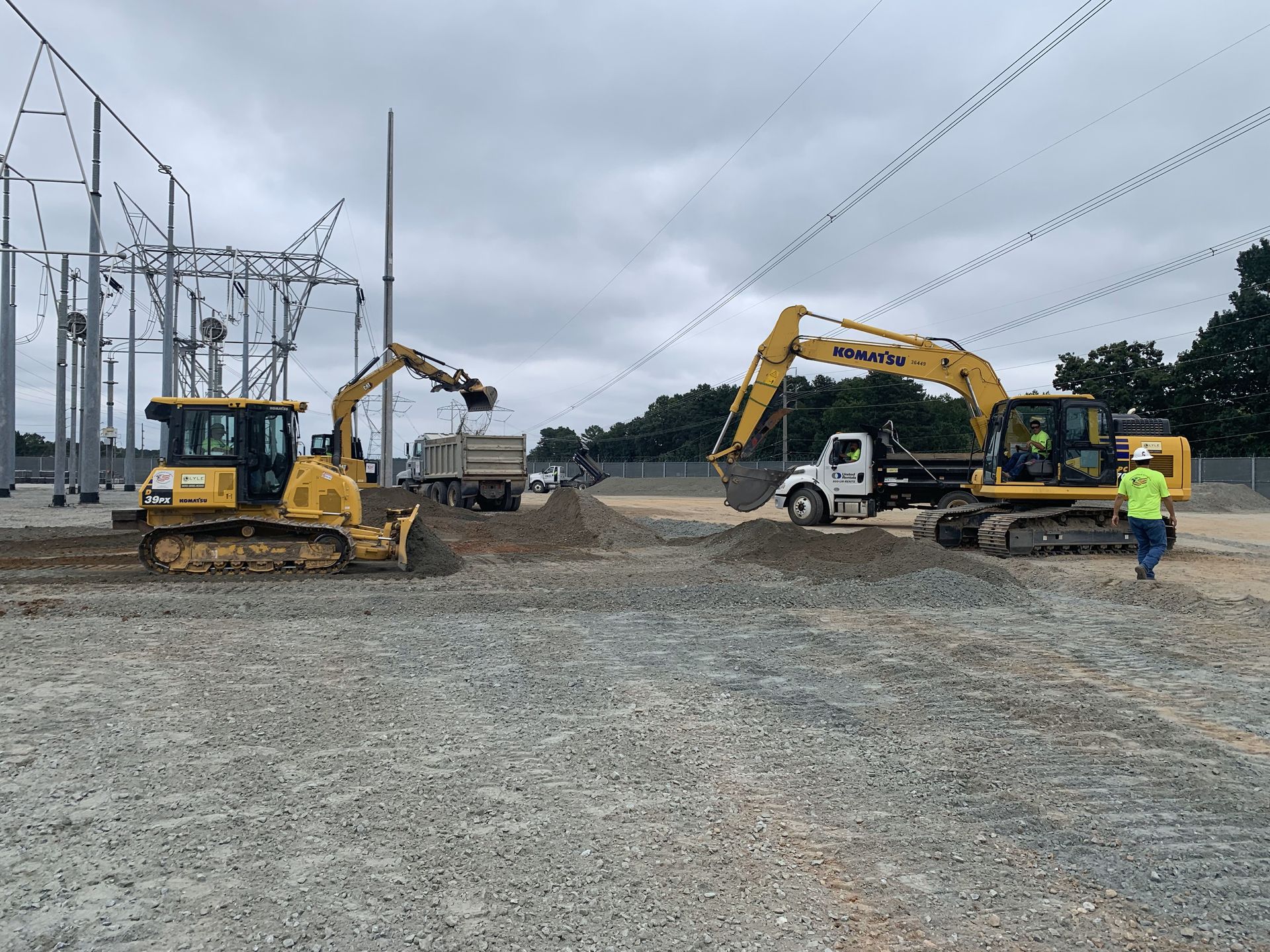 A bulldozer and an excavator are working on a construction site.