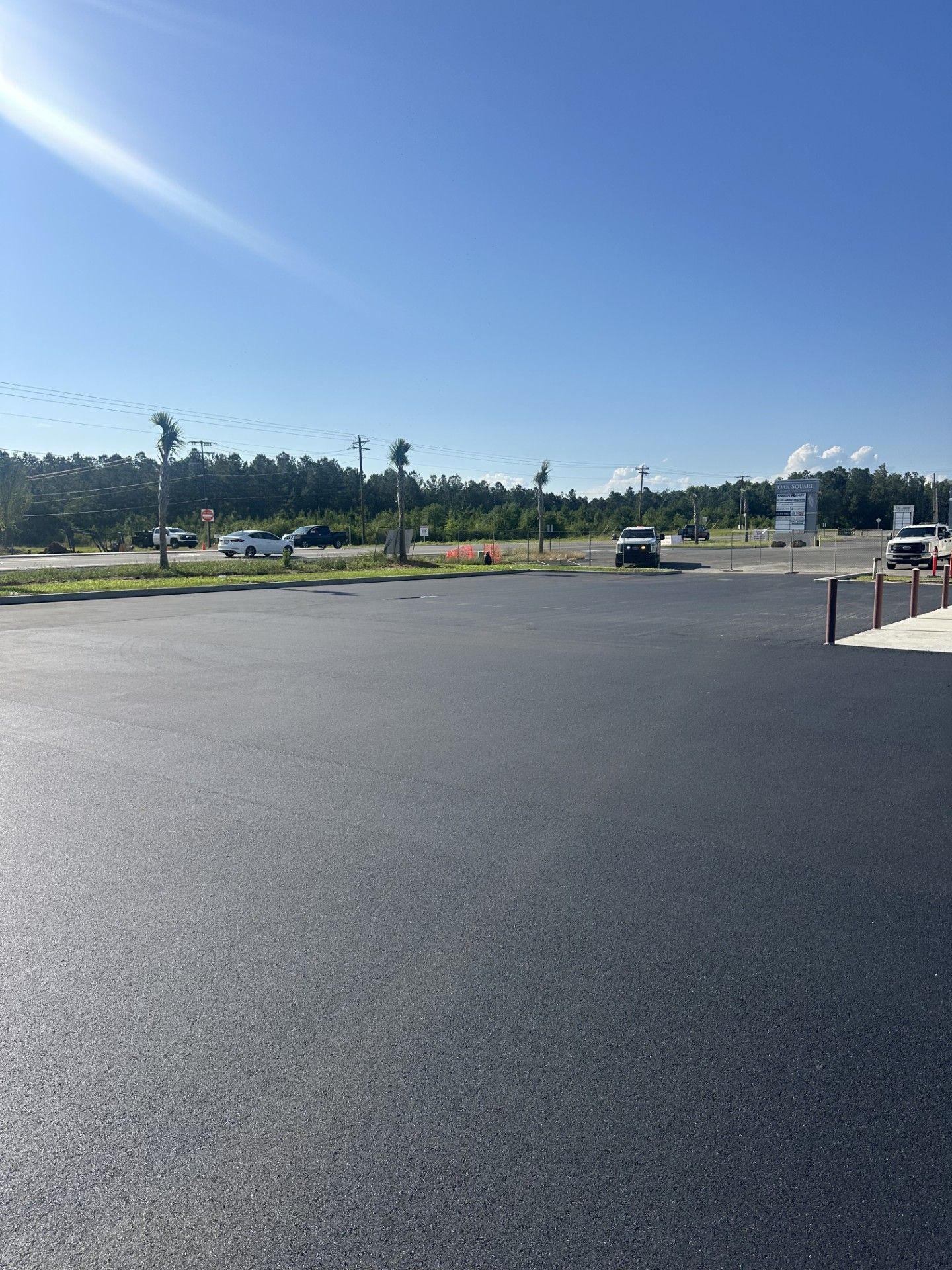 A parking lot with cars parked in it on a sunny day.