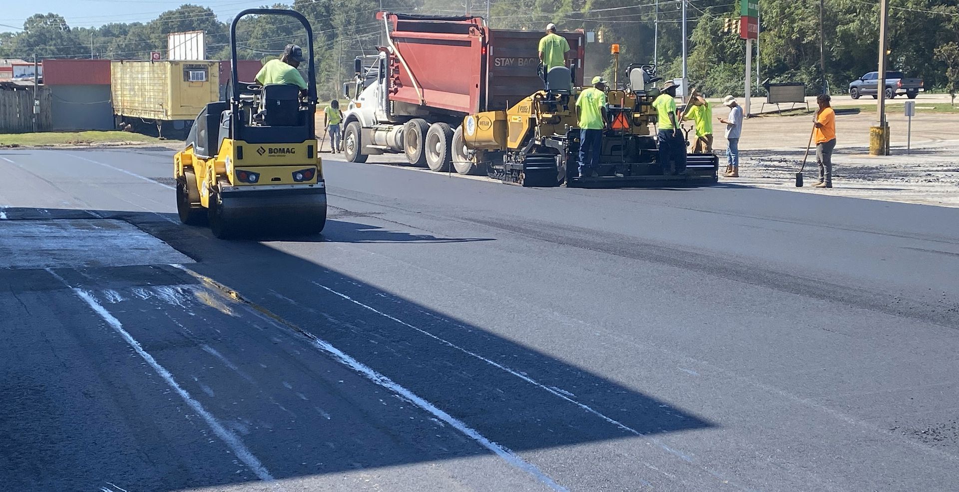 A group of construction workers are working on a road.
