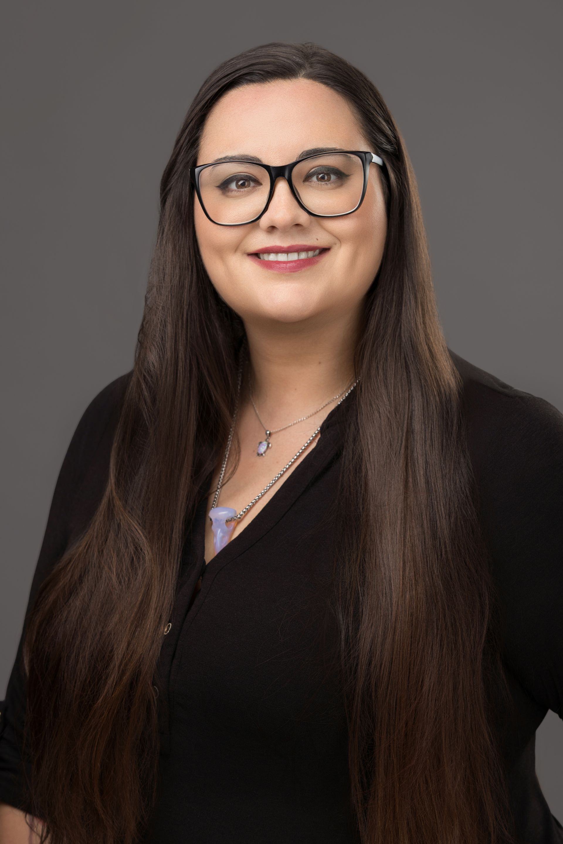 Silhouette of a person with short hair, against a gray background.