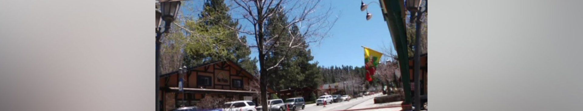 A blurry picture of a house in the woods with trees in the background.