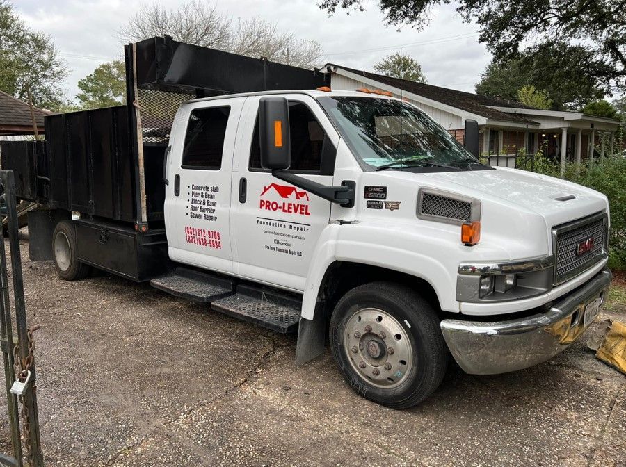 A white truck is parked in front of a house