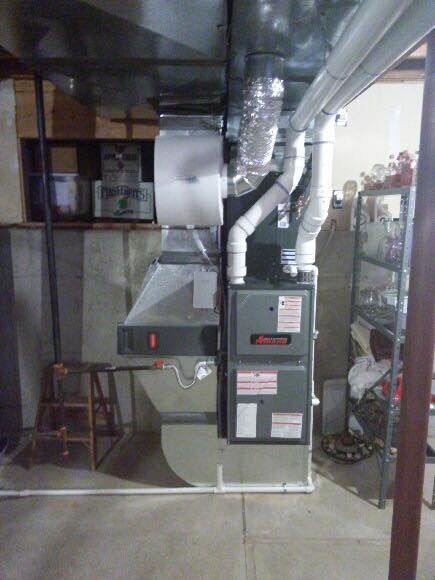 Furnace and ductwork in a basement setting. Gray and white components.