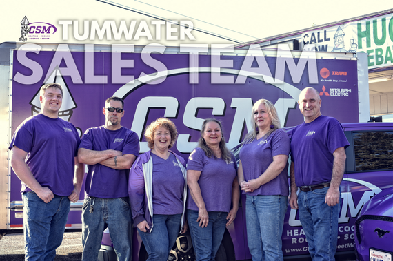 Group of six people in purple shirts, standing in front of a CSM van, smiling. 
