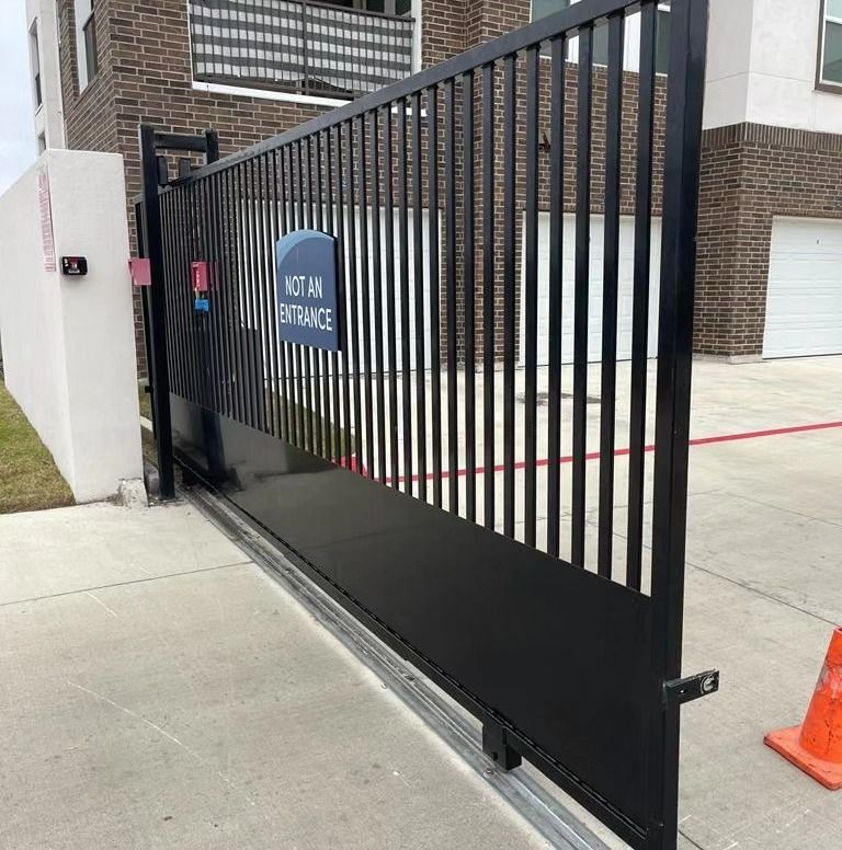 A sliding gate with a sign that says not an entrance.