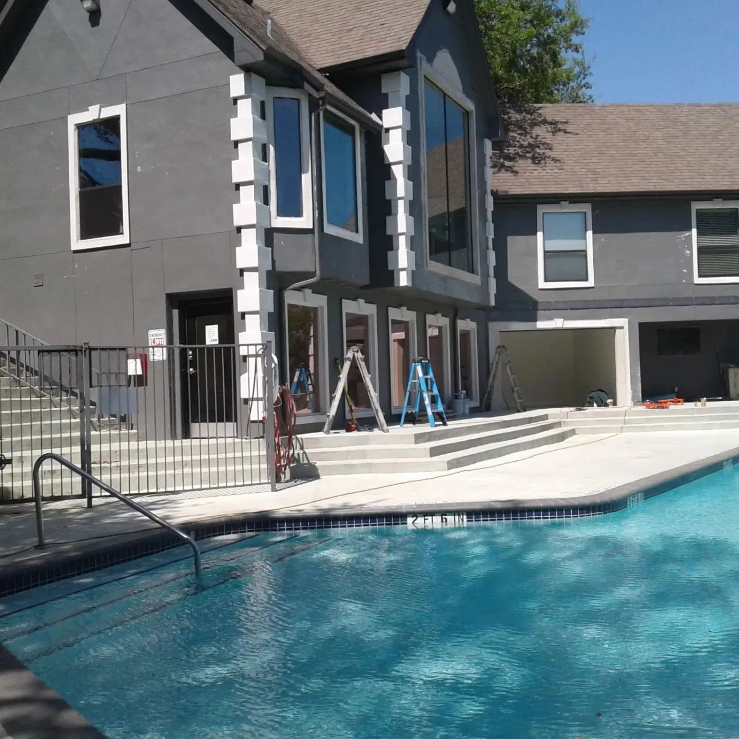 A large house with a swimming pool in front of it.