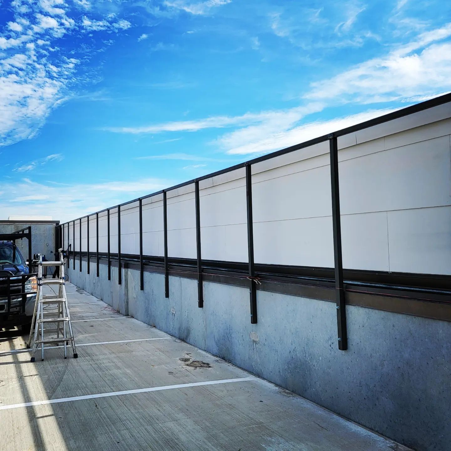 A fence with a blue sky in the background.