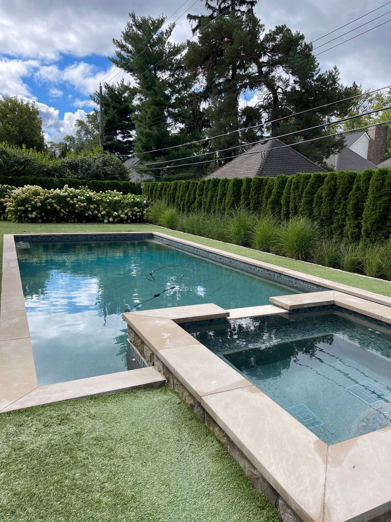 Outdoor in ground residential swimming pool in backyard