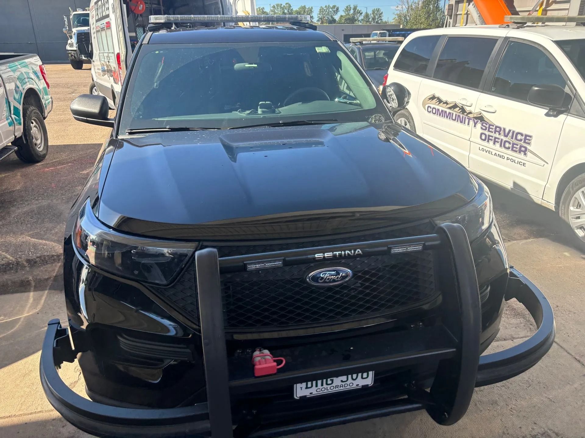 Black police SUV with a push bar, parked outdoors.