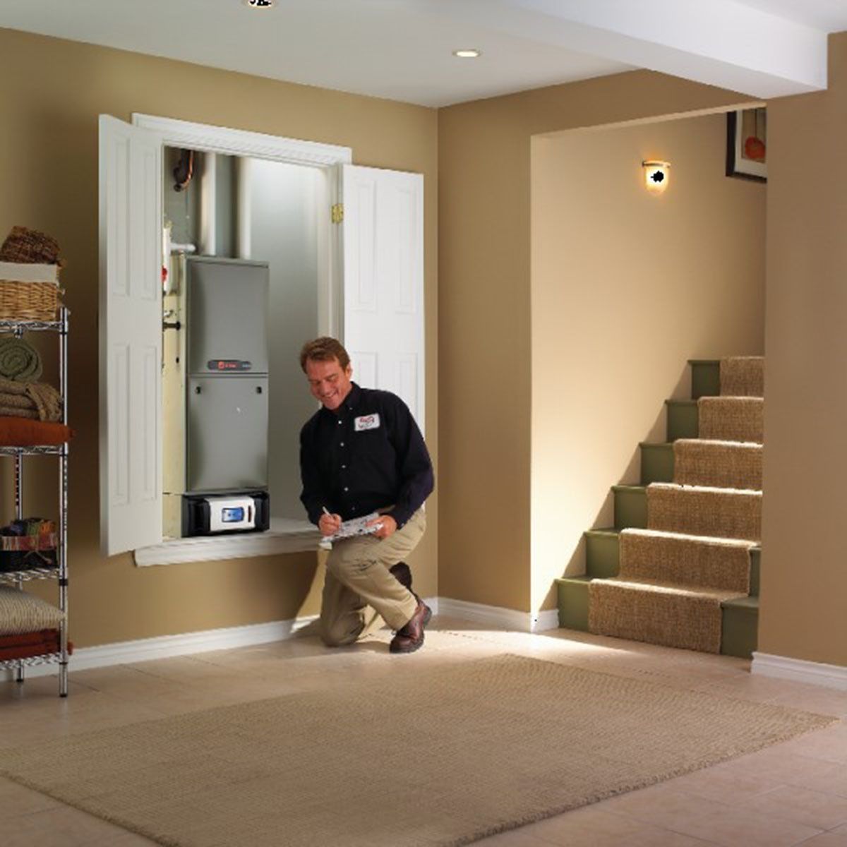 HVAC technician inspecting a furnace in a beige room; open cabinet doors, stairs visible.