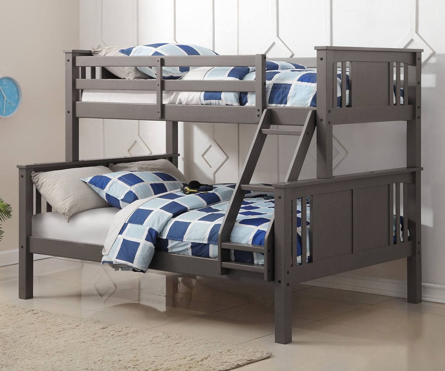 Gray bunk bed with bedding, ladder, against a light gray wall.