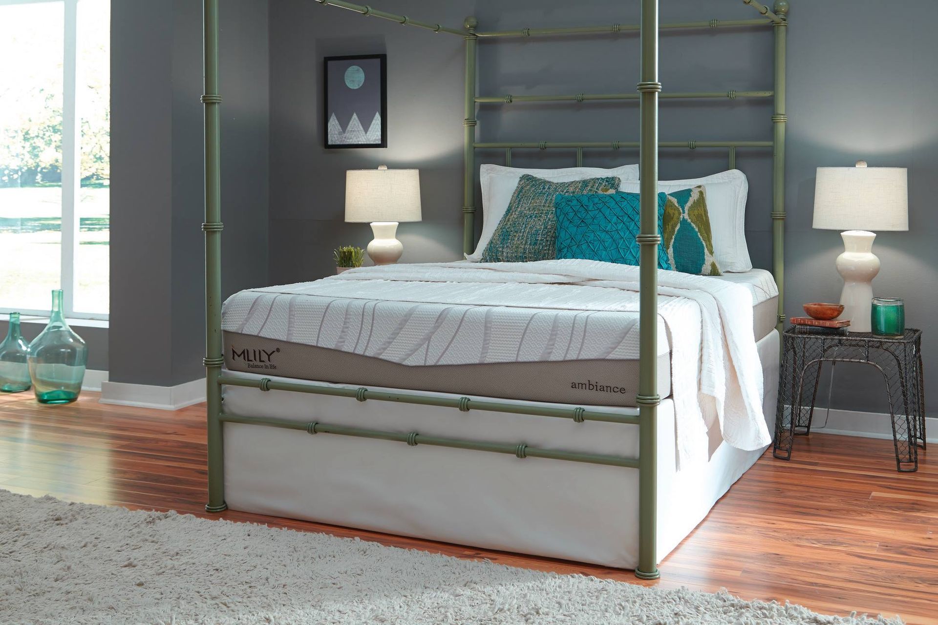 A bed with a bamboo-style frame, topped with white bedding, pillows, and two bedside lamps.