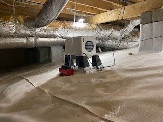 There is a fan in the attic of a house.