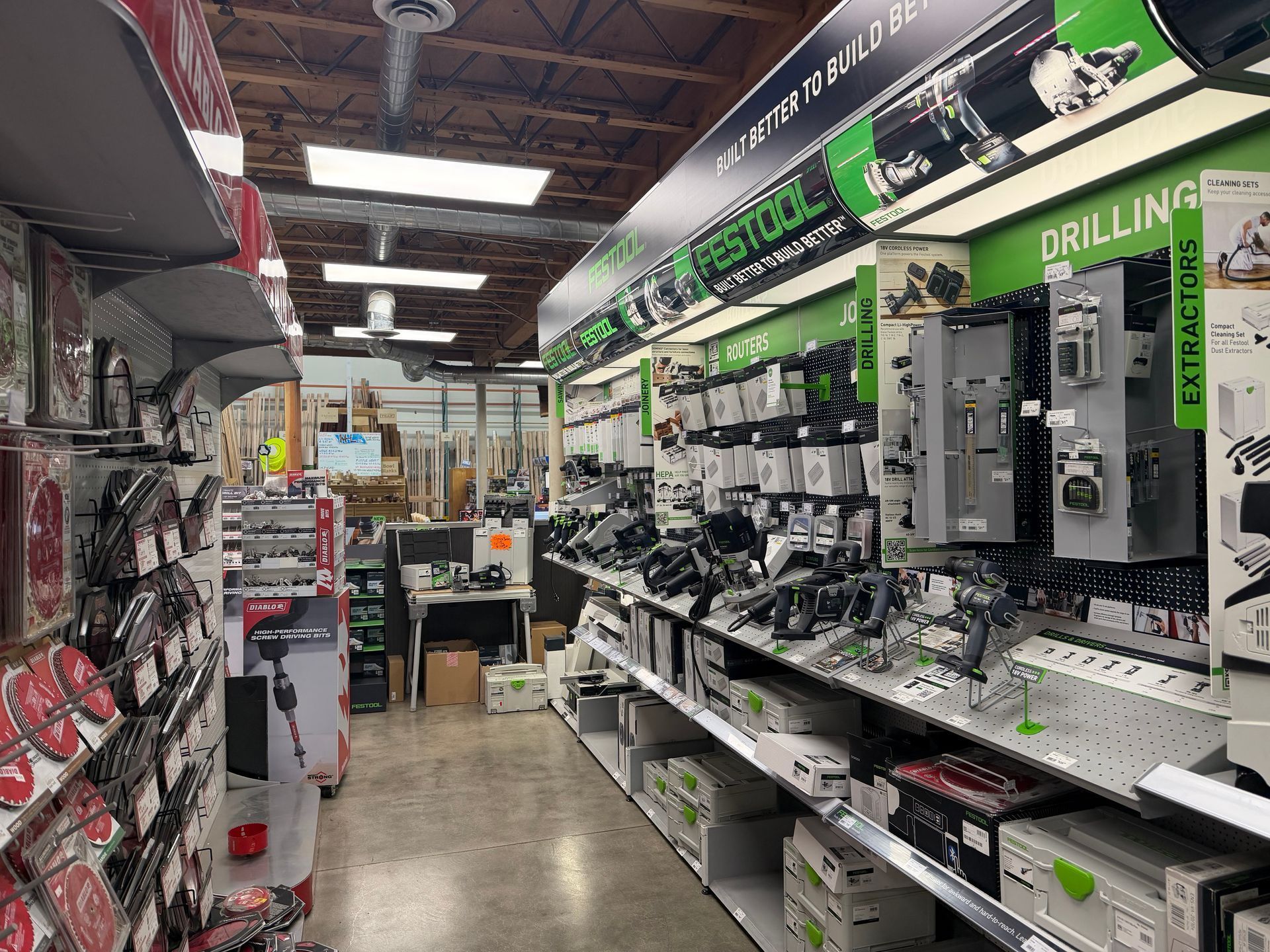 Interior of a hardware store aisle with tools and equipment displayed on shelves.