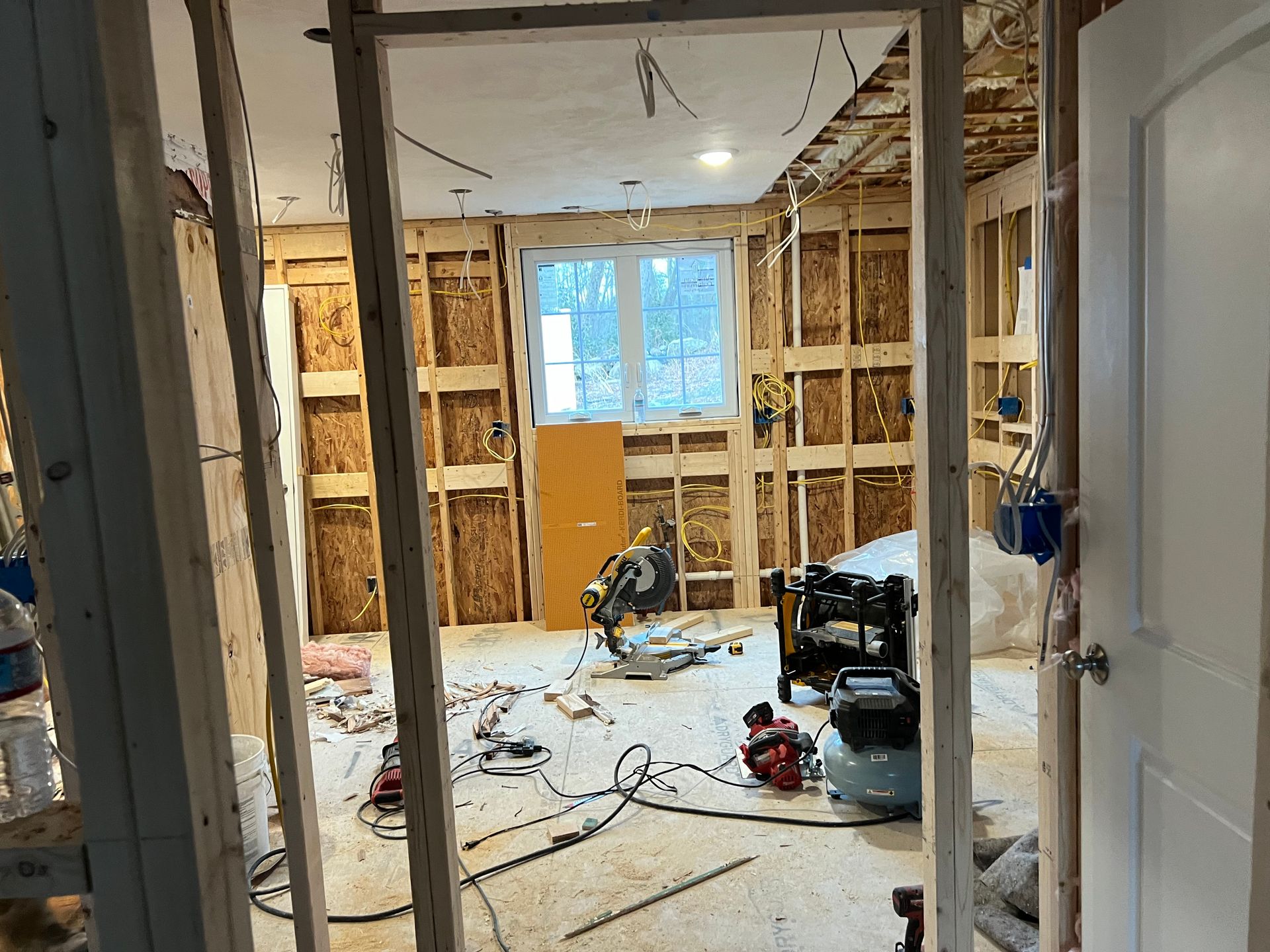 A room that is being remodeled with a lot of tools on the floor.