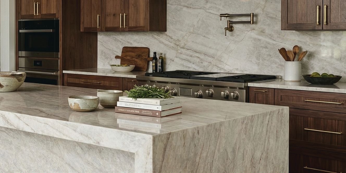 Modern kitchen with stone island, dark wood cabinets, and stainless steel appliances