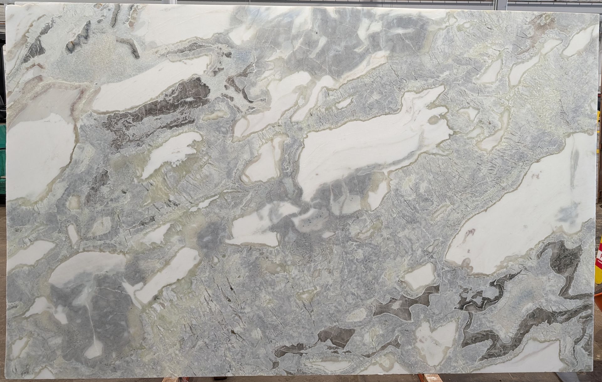 Gray and white marble slab with veined, mottled stone pattern.